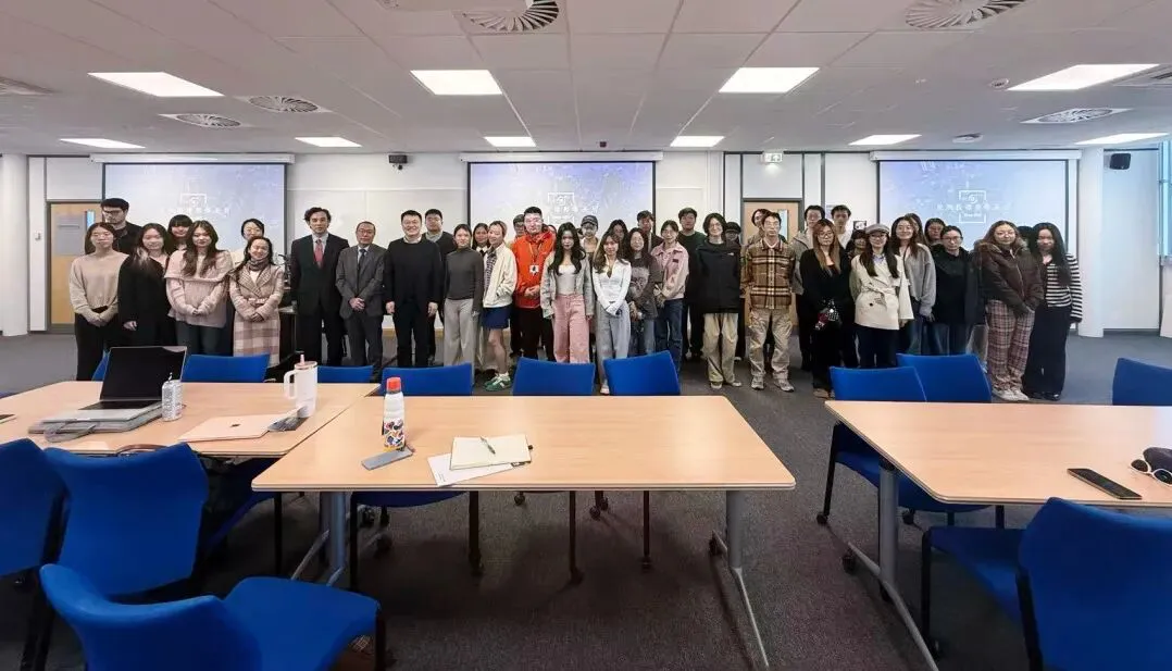 Students and speakers standing together in a seminar room at the University of Leeds after the Duan & Duan talk