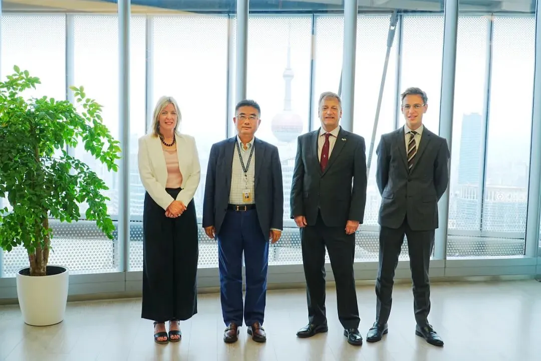 Members of the Law Society delegation and Wu Jian of Duan & Duan standing by the windows of Duan & Duan's Shanghai office